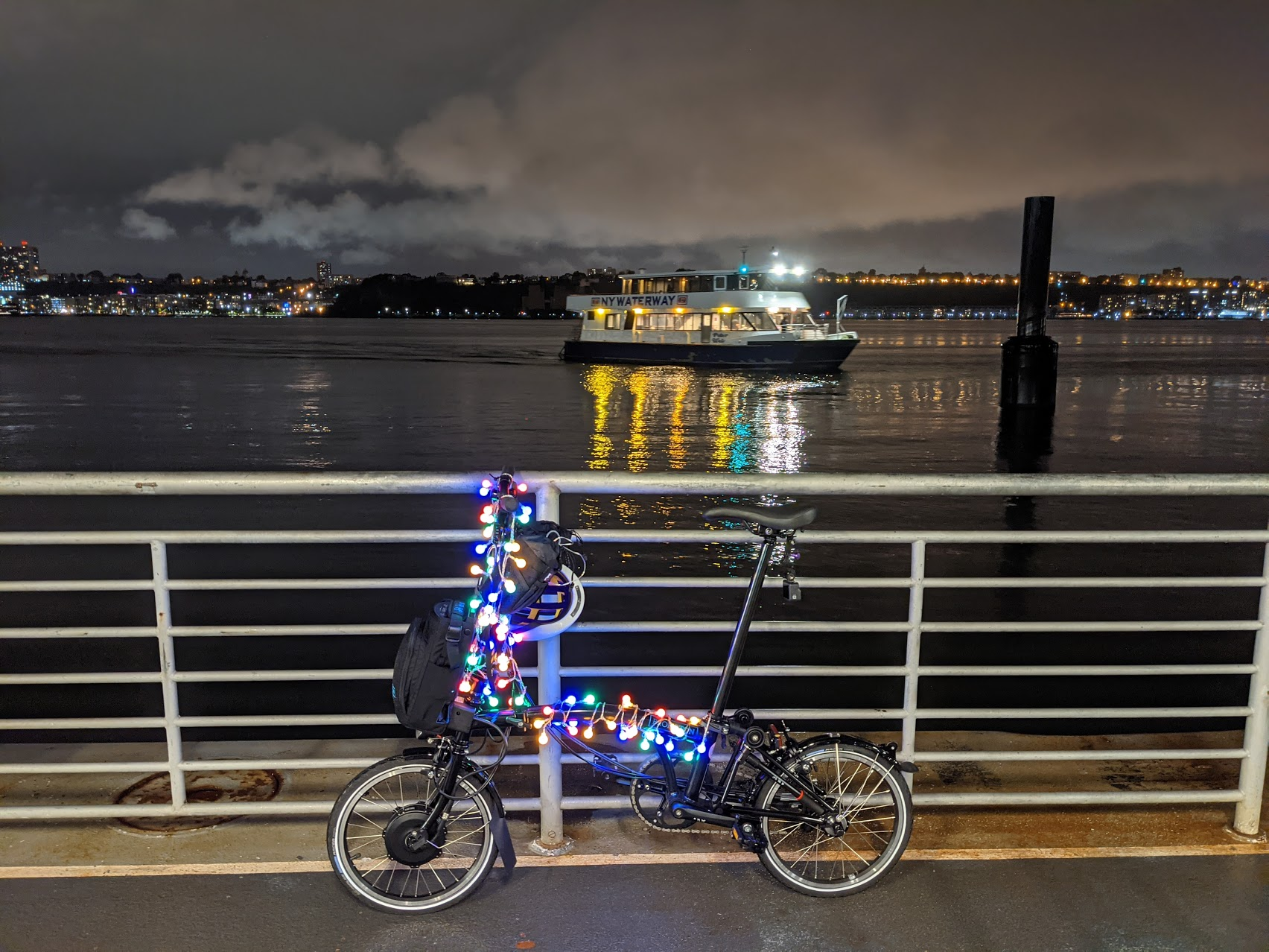 Brompton Electric with cheap Amazon party lights, waiting for ferry