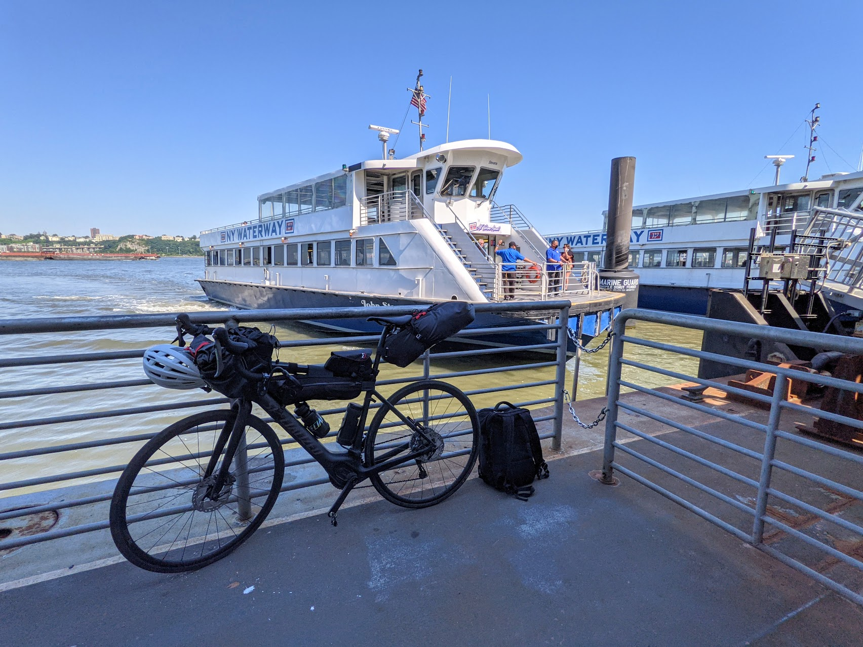 Creo laden with bags, and backpack on the side, at NY Waterway ferry terminal as boat comes in