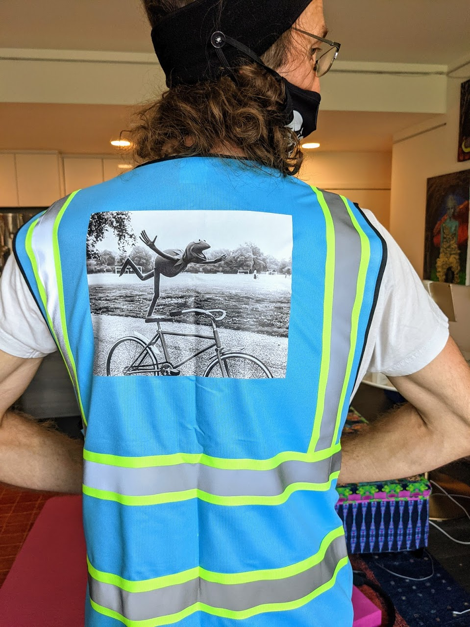 blue hi-viz vest with an image of Kermit standing one-legged on a bicycle seat