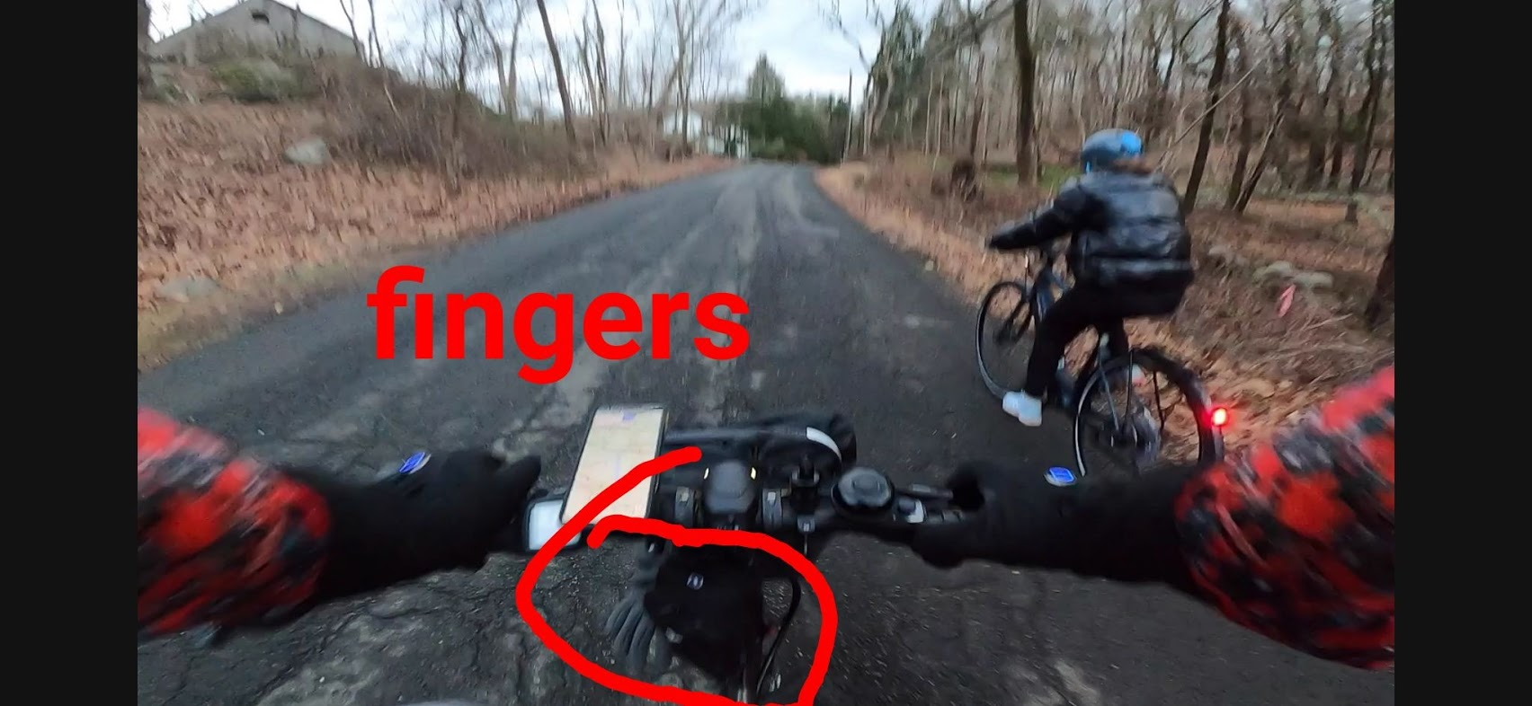 Cockpit view showing extra glove falling out of basket onto road while hitting a pothole