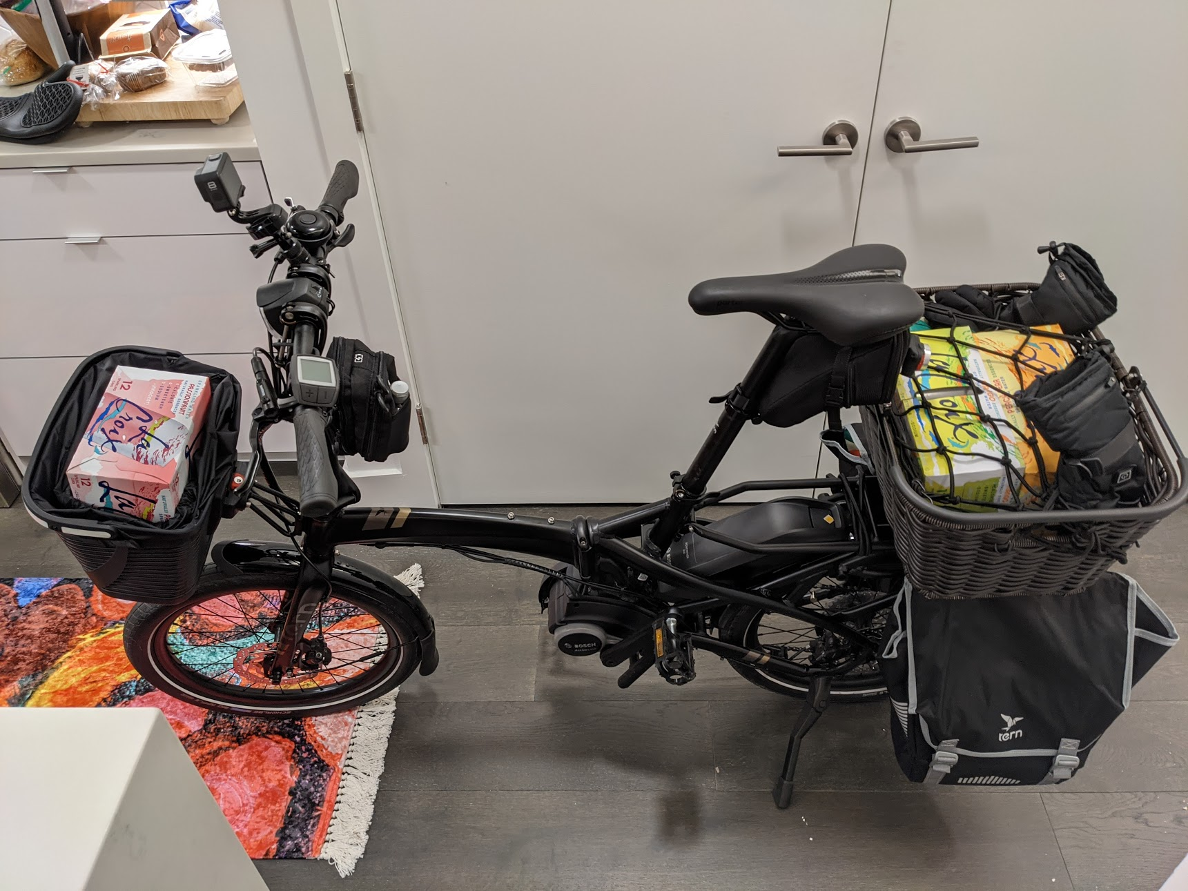 Tern Vektron Q9 laden with groceries in front basket, rear basket, and 2 panniers